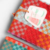 kitchen towels with bright coloured small checks on a white background and a product label