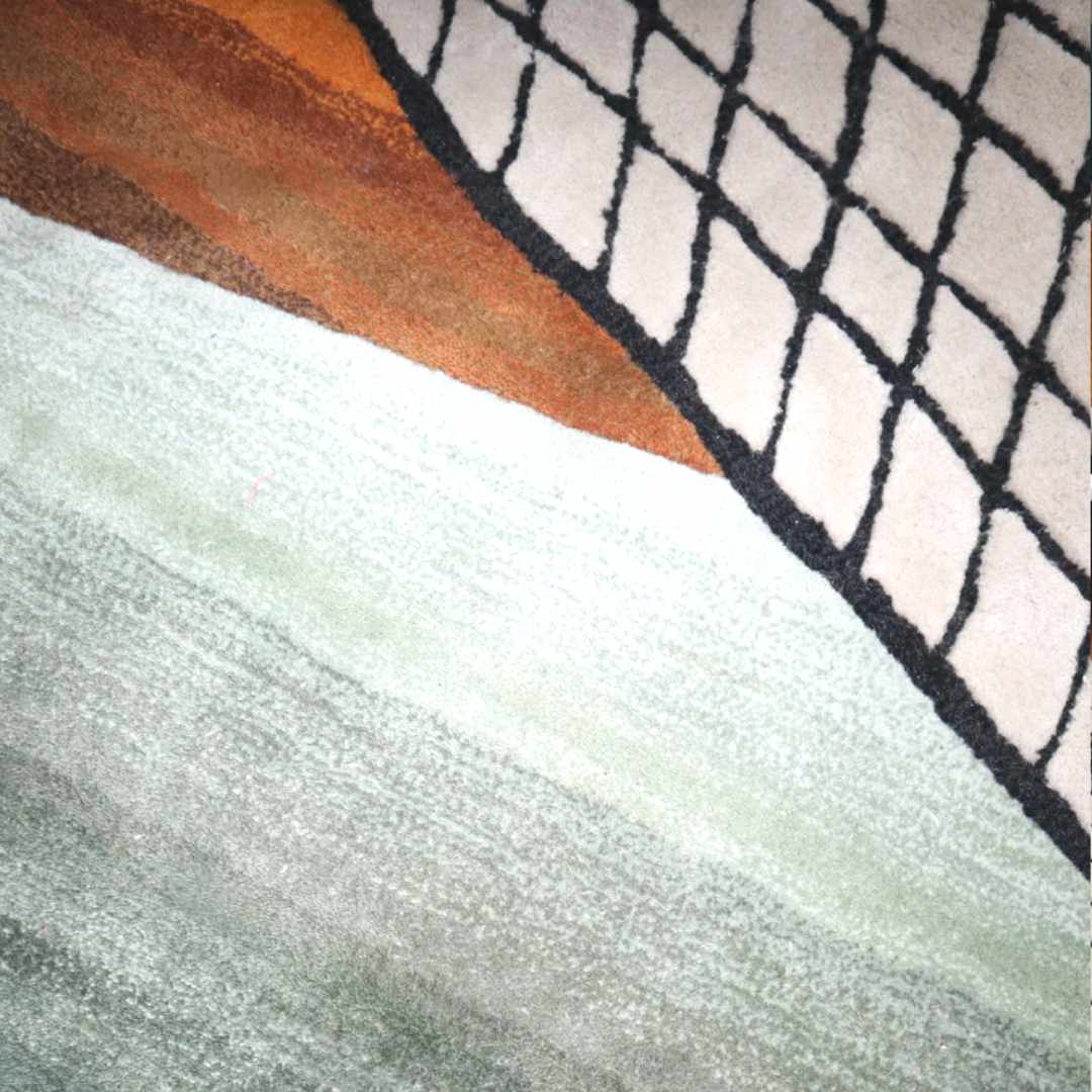 close up of Take the Grip - Captivating Tufted Wool Carpet by Trine Krüger | Gradient Mint to Green with Striking Orange Hues | Black and White Grid Pattern | Non-Rectangular Organic Shape | Iconic Modern Art for Contemporary Living Spaces