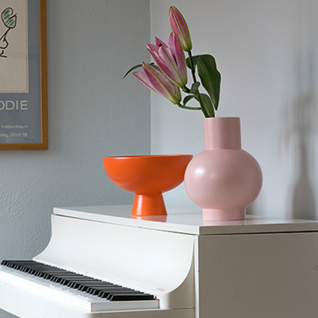 Medium sized Strøm Bowl in Vibrant Orange on Piano with Vase, Scandinavian Earthenware by Nicholai Wiig Hansen for Raawii - available at NAVE Shop - online concept store